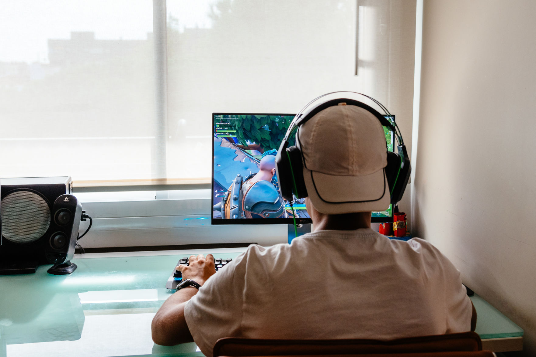 Teenager playing Fortnite video game on PC (copy)